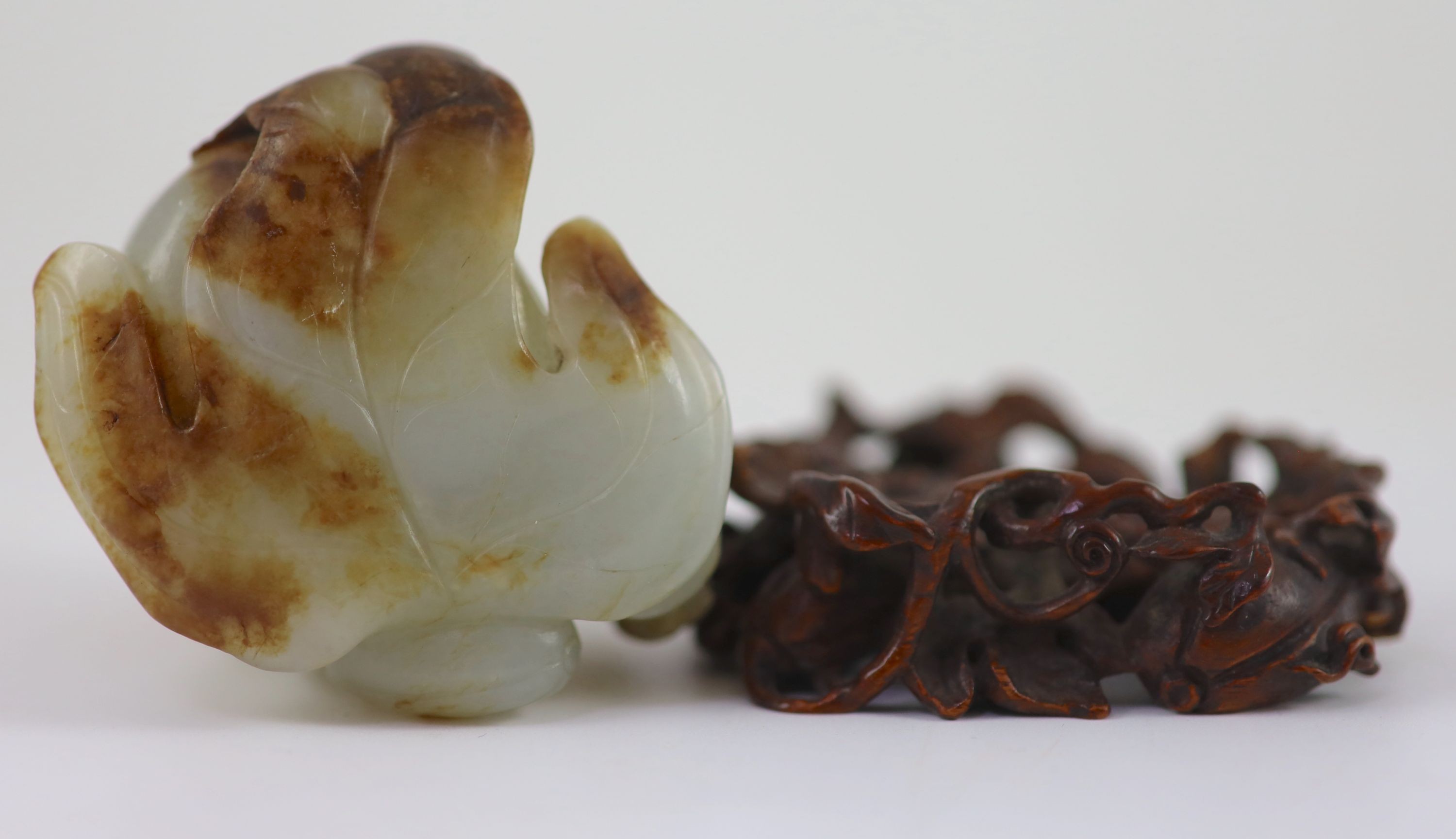 A Chinese pale celadon and russet jade 'boy' jar and cover,carved in openwork and high relief with a - Image 3 of 4