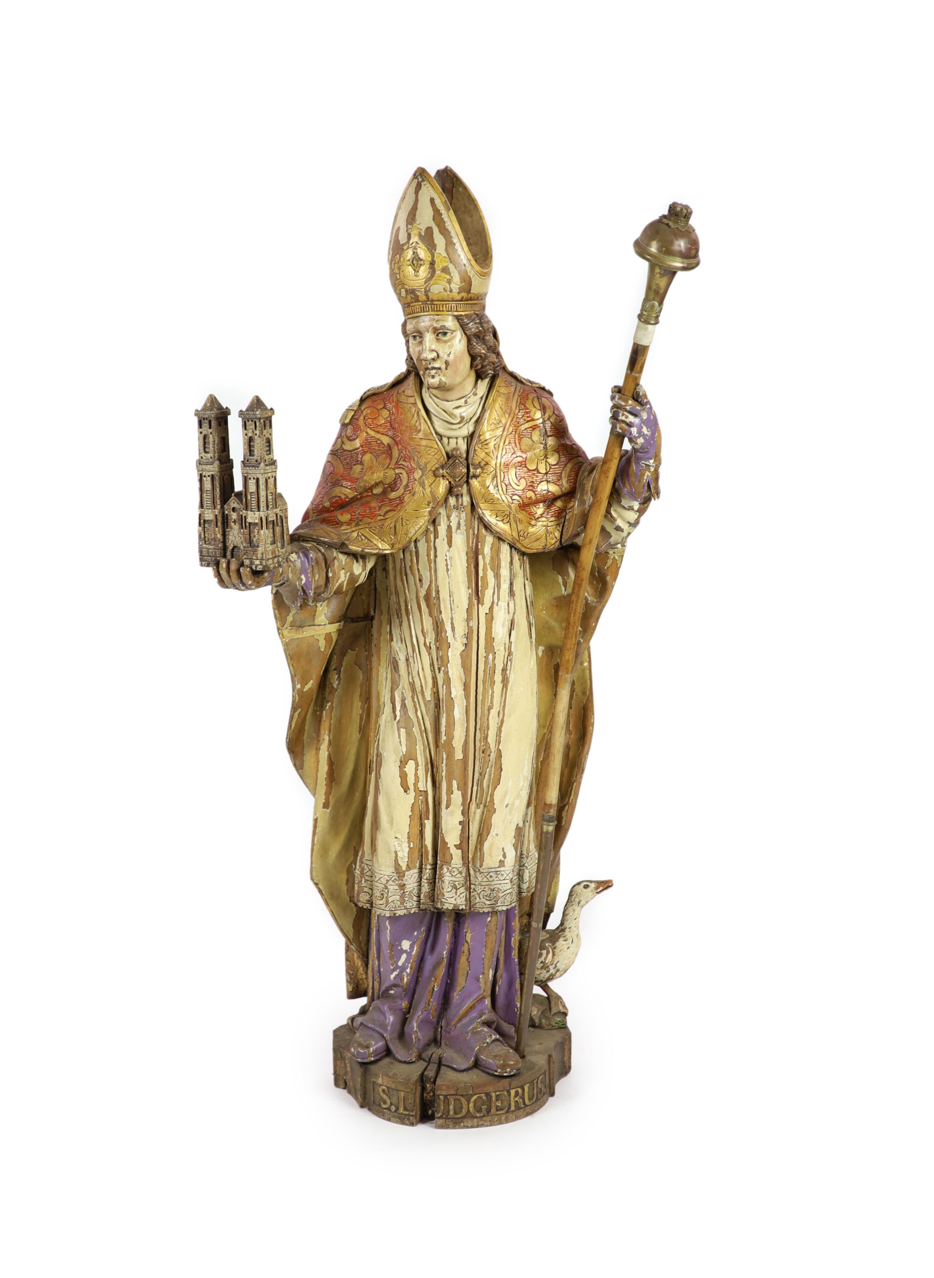 A 19th century German painted carved wood figure of St Ludgerus (b.742)standing holding a