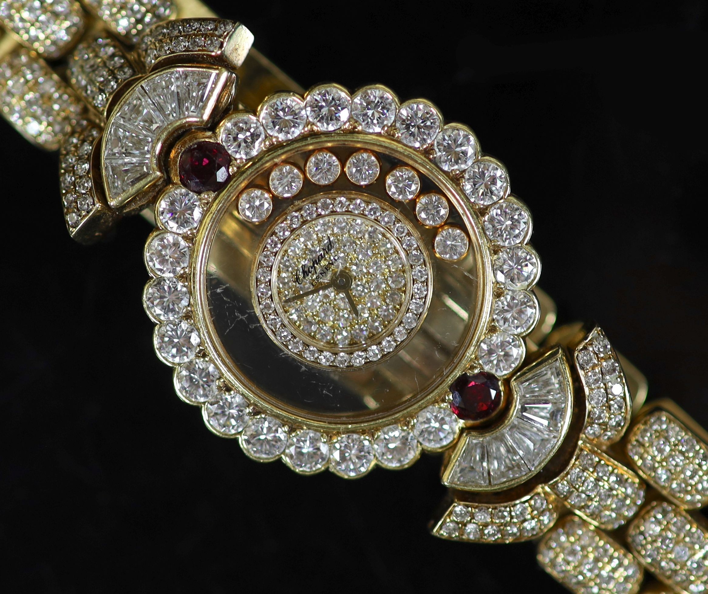 A lady's Chopard 'Happy Diamonds' 18ct gold, ruby and diamond encrusted dress wrist watch,set with