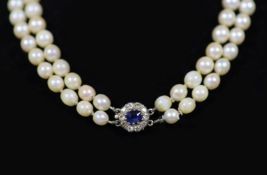An early 20th century double strand graduated cultured pearl choker necklace, with sapphire and