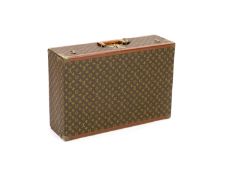 A Louis Vuitton LV pattern suitcasewith brass mounts and leather banding,70 x 47 x 22cm