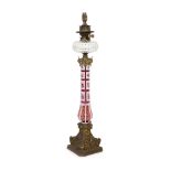 A Victorian ormolu mounted Bohemian ruby overlaid glass oil lamp,enamelled with floral sprays on