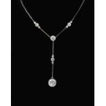 A 1920's platinum and eleven stone diamond set drop pendant necklace,the largest diamond weighing