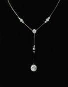 A 1920's platinum and eleven stone diamond set drop pendant necklace,the largest diamond weighing
