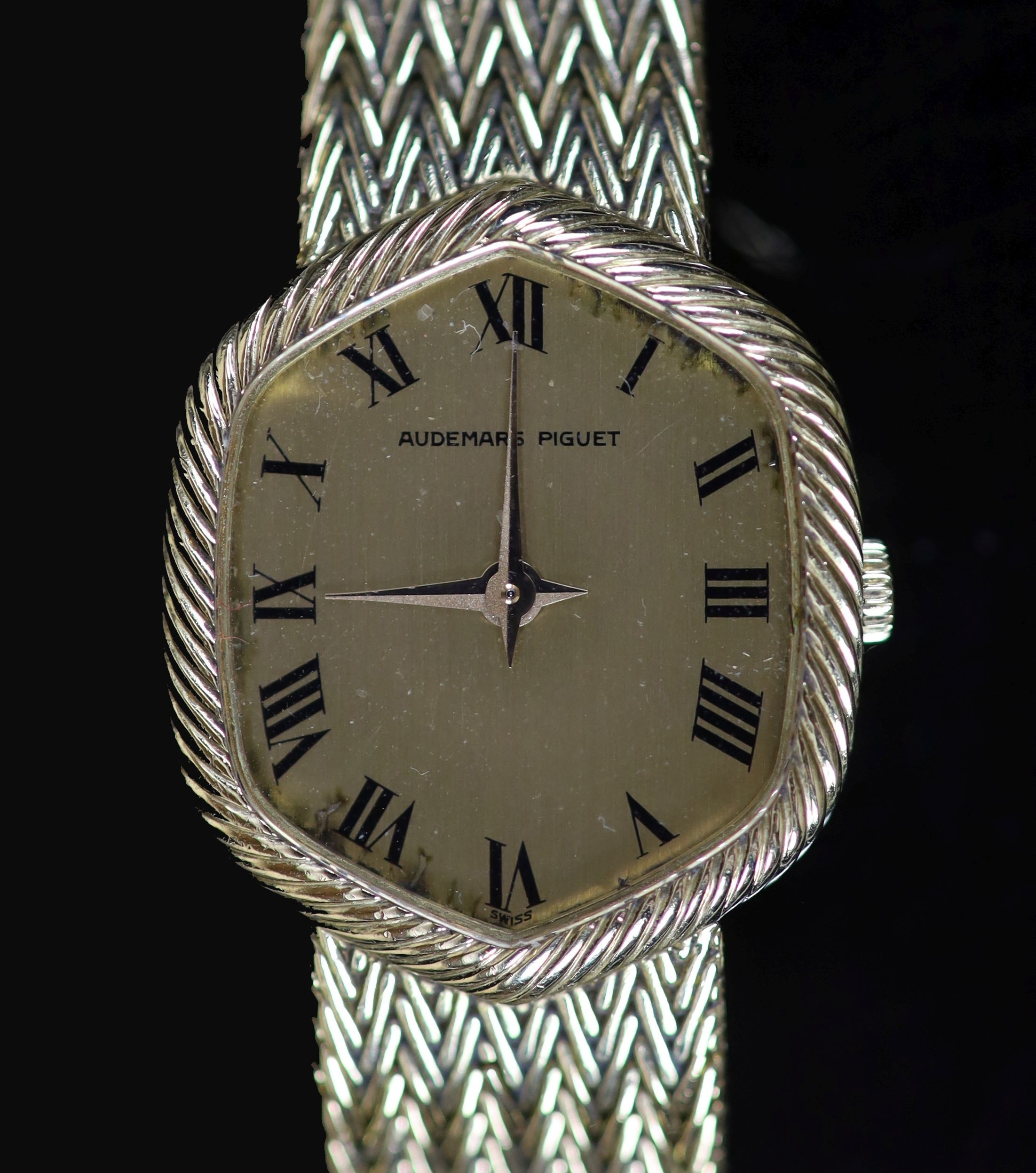 A lady's 18ct gold Audemars Piguet manual wind wrist watch,with hexagonal Roman dial, on integral