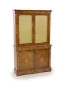 A Victorian ormolu mounted marquetry inlaid walnut bookcase,with moulded cornice and two glazed