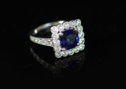 A modern 18ct white gold, sapphire and millegrain set diamond square cluster ring,the sapphire