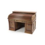 A late 19th century American walnut and mahogany 'Wootton' desk,with tambour over three frieze