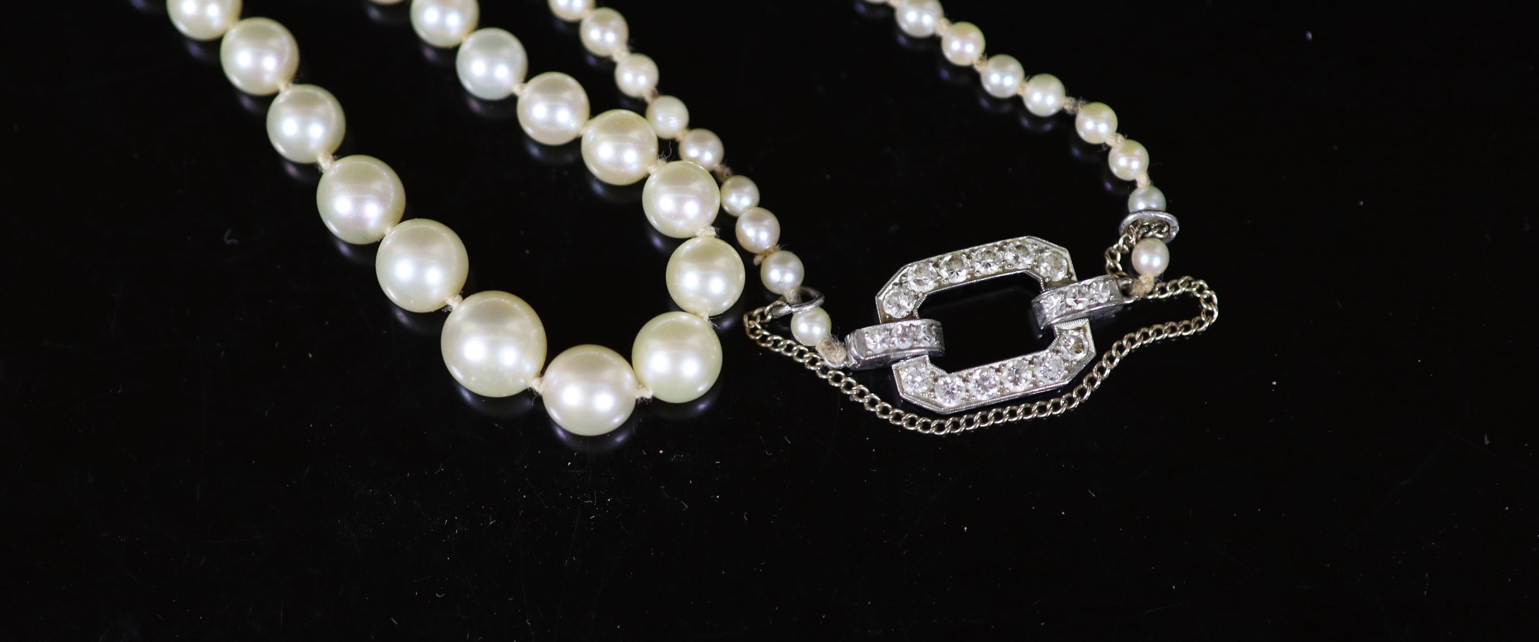 A mid 20th century single strand graduated pearl necklace, with platinum and diamond set open work - Image 2 of 3
