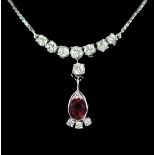 A modern Italian 18ct white gold, single stone oval cut ruby and eleven stone diamond set drop