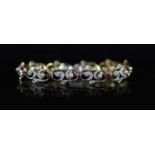 A 1940's/1950's gold and platinum, ruby and diamond set open work scroll link bracelet,18cm, gross