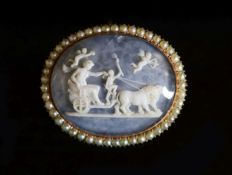 An early 20th century gold and seed pearl set oval glazed cameo brooch,depicting a figure in a