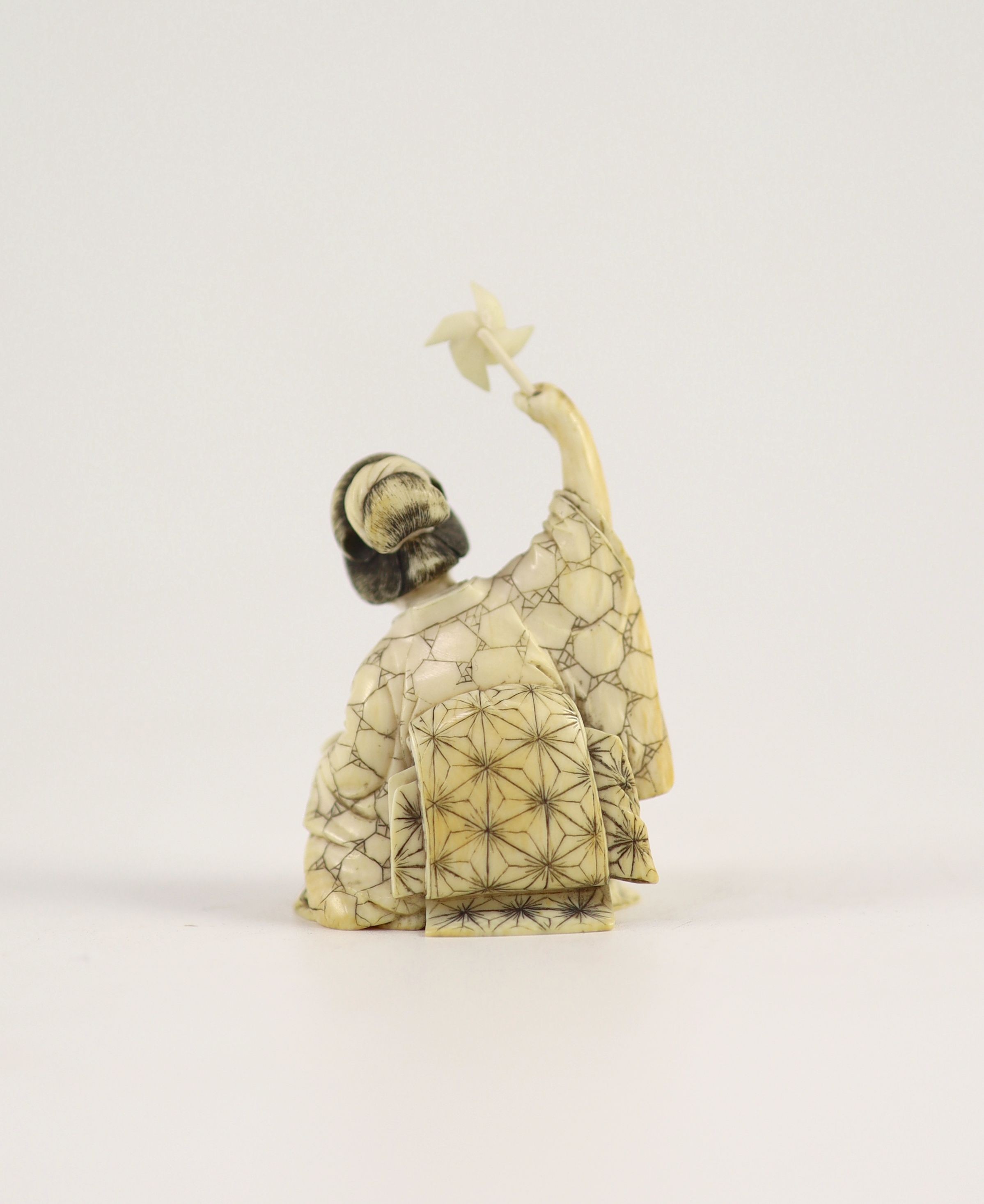 A Japanese ivory okimono of a mother and child, Meiji period,both kneeling, the mother holding a toy - Image 2 of 3