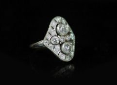 A 1930's/1940's platinum and millegrain set diamond cluster dress ring,of quatrefoil shape, the