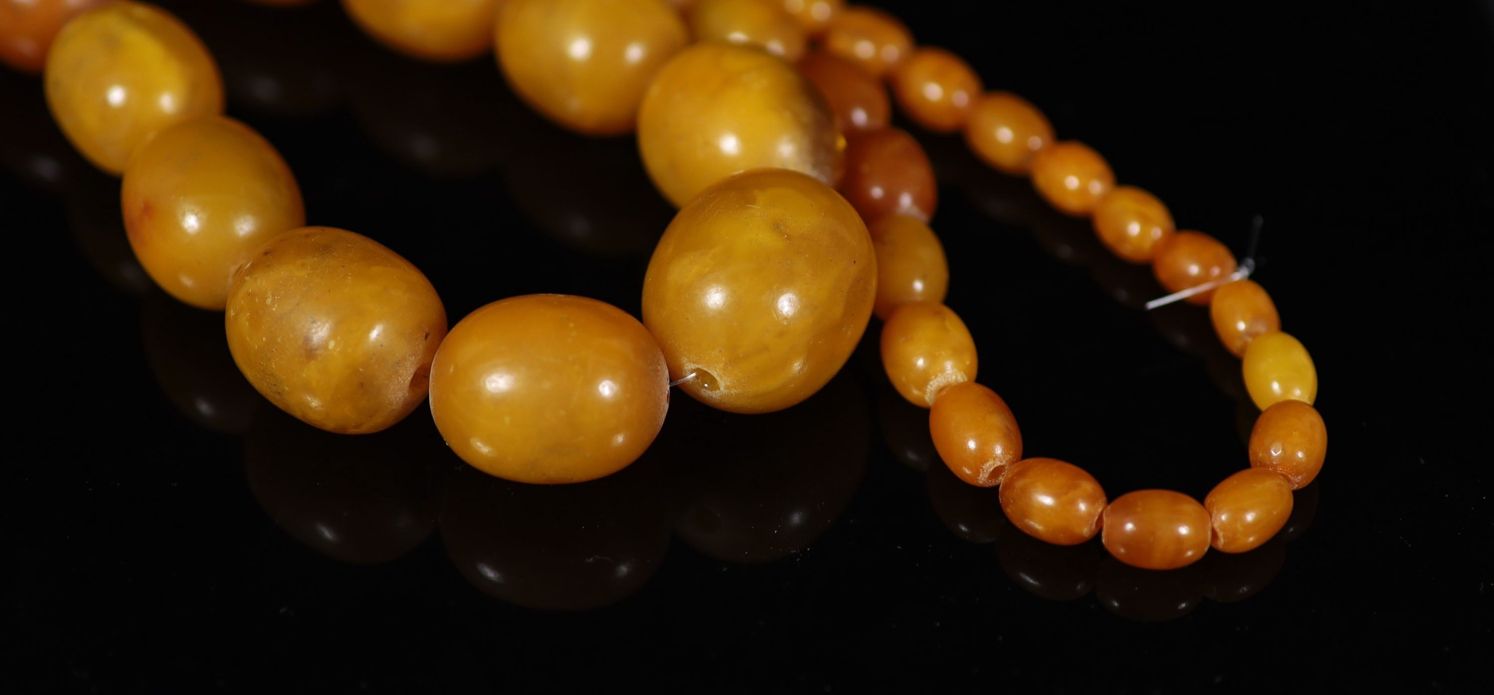 A single strand graduated oval amber bead necklace, 84cm, gross weight 118 grams. - Image 2 of 3