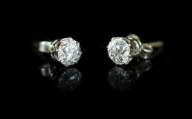 A pair of white gold and solitaire diamond ear studs,one stone diameter 5mm, the other 5.2mm,