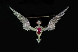 A late Victorian gold, foil backed pear cut ruby and old mine cut diamond encrusted brooch, modelled