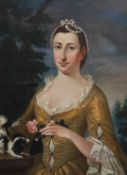 Early 18th century French School Portrait of a lady wearing a yellow dress holding a rose with a lap