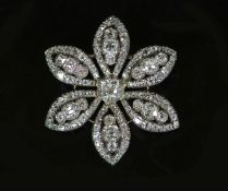 An early 19th century gold, silver and diamond encrusted flower head pendant, with detachable brooch