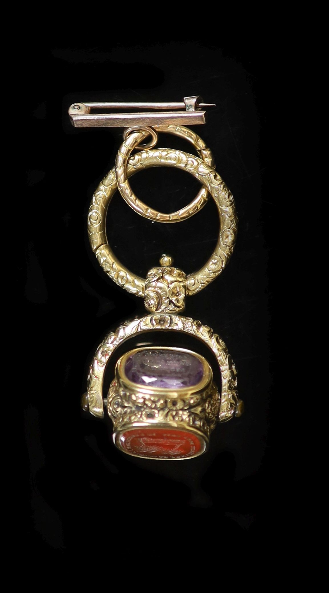 An early 19th century gold overlaid and three stone set swivelling fob seal,each matrix carved