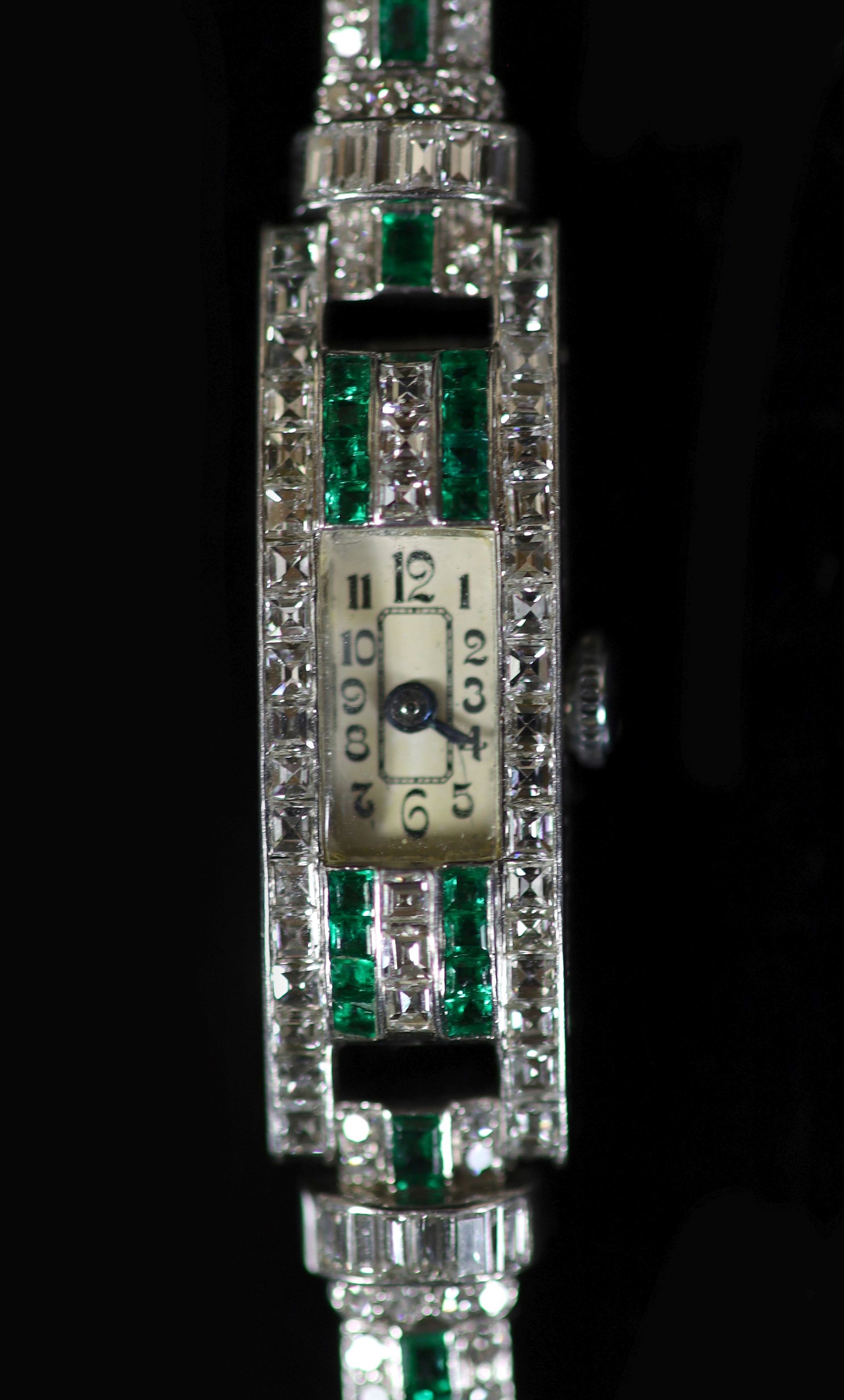 A lady's 1940's/1950's engraved platinum, emerald and diamond set manual wind rectangular cocktail