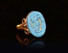 An antique gold and oval turquoise glazed intaglio set ring,the ancient Egyptian matrix indistinctly