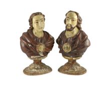 A pair of early 19th century Spanish carved and painted busts of saints,with parcel gilt