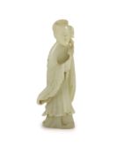 A Chinese pale celadon jade figure of a lady, 18th century,standing and holding a flower sprig,