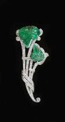 A 1940's French 18ct white gold, carved emerald, baguette and round cut diamond set floral spray