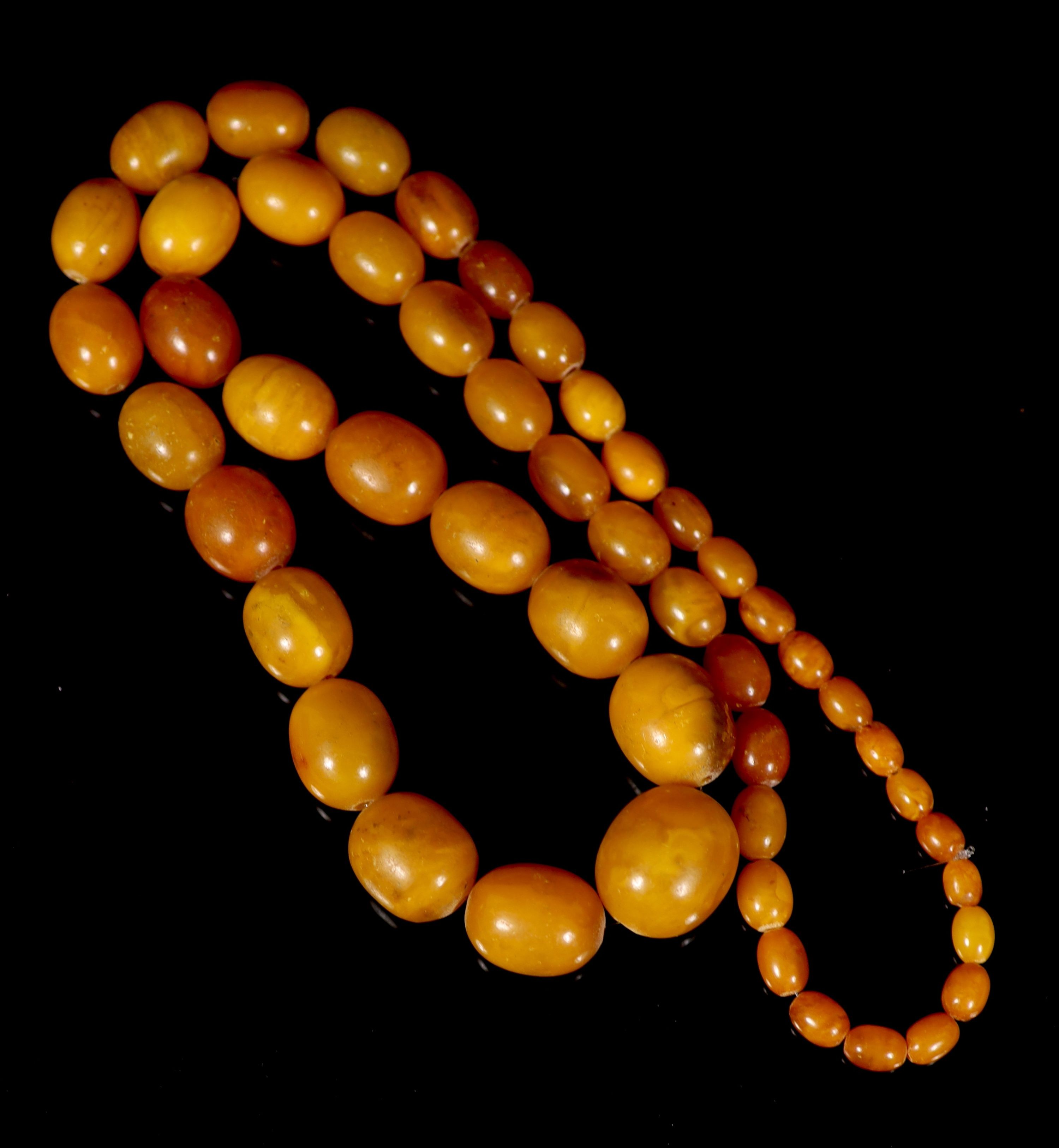 A single strand graduated oval amber bead necklace, 84cm, gross weight 118 grams. - Image 3 of 3