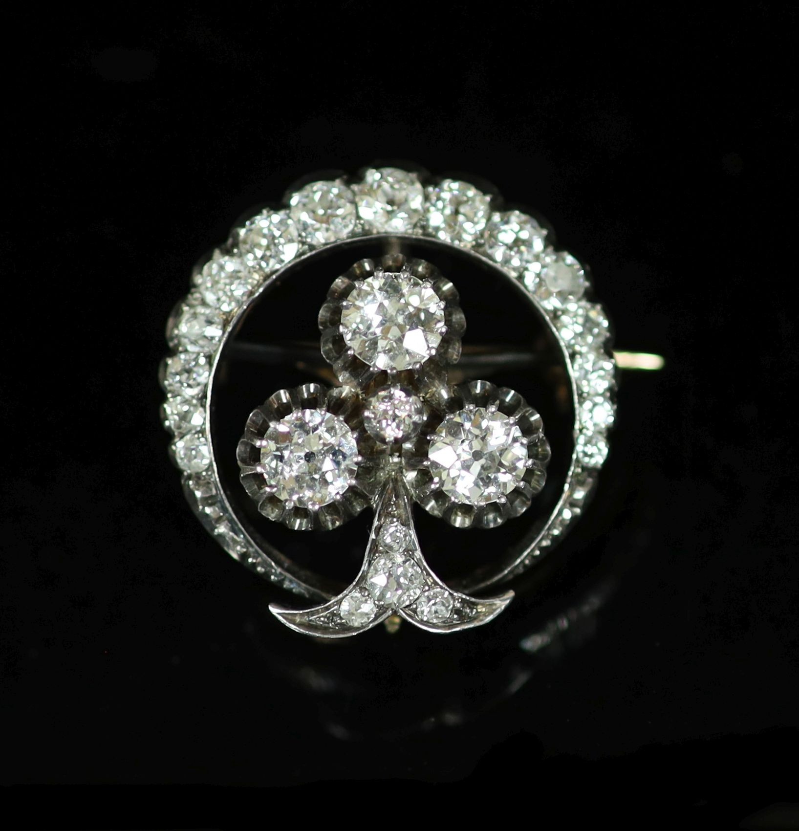 A late Victorian gold, silver and diamond cluster set 'crescent and clover' circular brooch,the