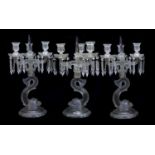 A pair of Baccarat moulded and frosted glass candelabra and another similar, late 19th century,the