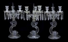 A pair of Baccarat moulded and frosted glass candelabra and another similar, late 19th century,the