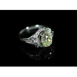 A white gold and oval cut solitaire diamond ring, in a raised claw setting,the stone weighing