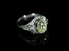 A white gold and oval cut solitaire diamond ring, in a raised claw setting,the stone weighing