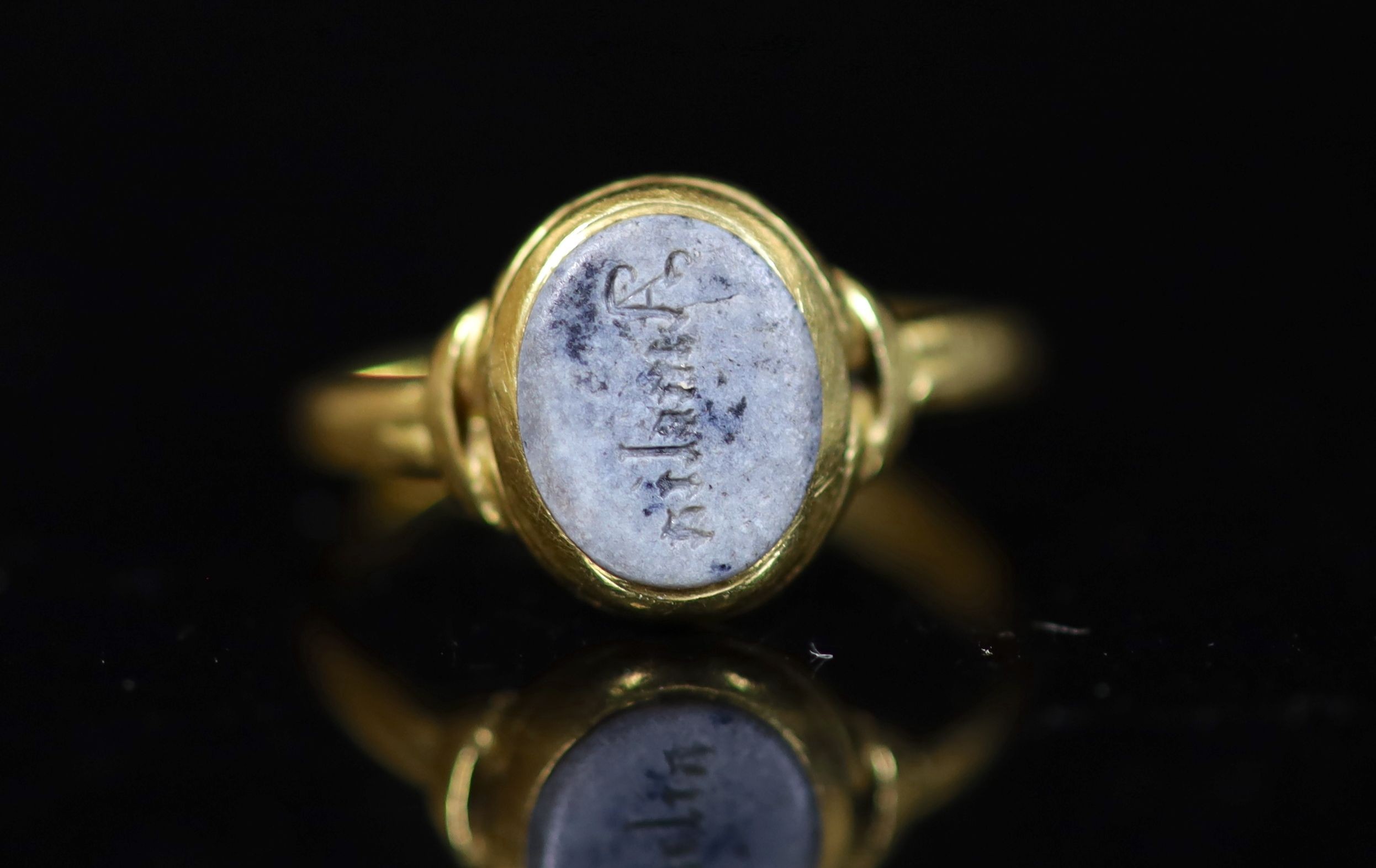An antique gold and oval chalcedony set ring, carved with the name 'Amelia',size L, gross weight 2.3 - Image 2 of 3