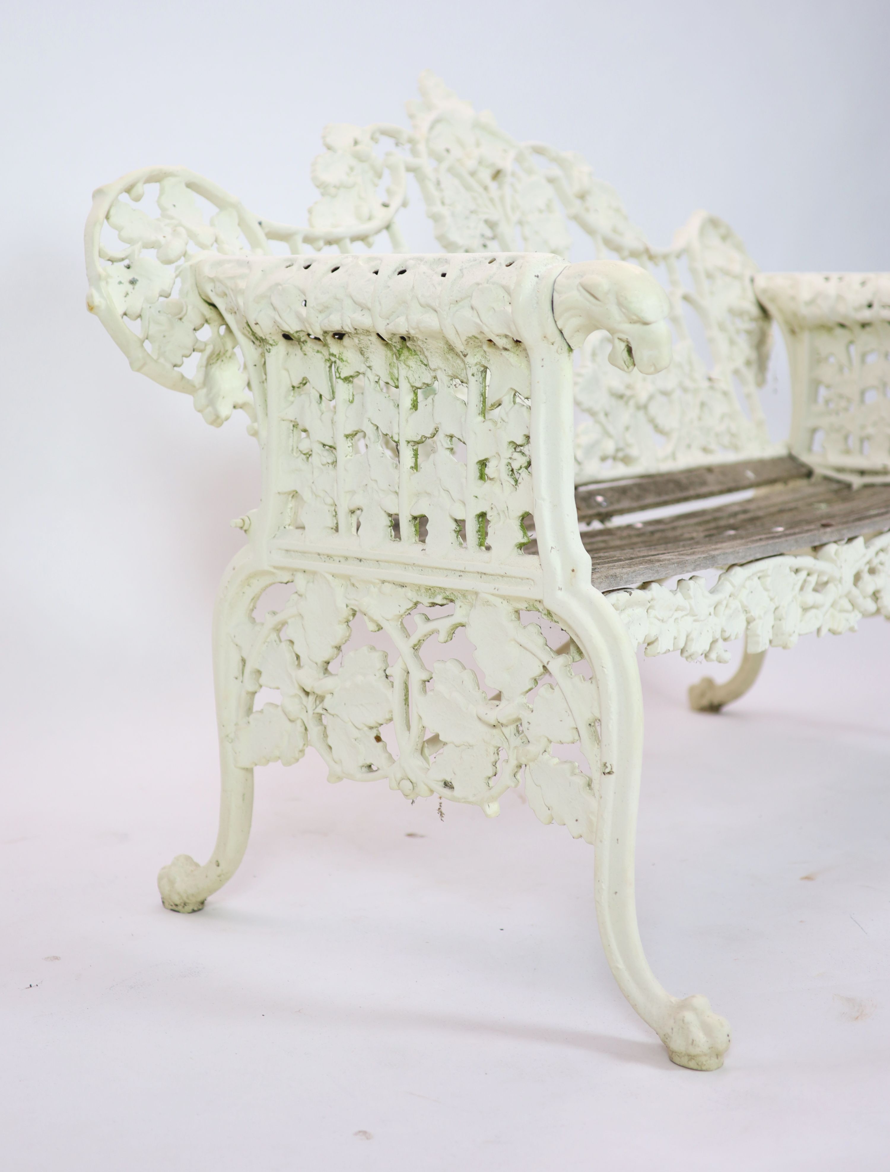 After Coalbrookdale, a pair of cast iron ‘Oak and ivy' bencheswith white paintwork and teak - Image 2 of 4