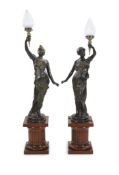 A pair of 19th century style bronze figural torcheres,each modelled as a classical maiden holding
