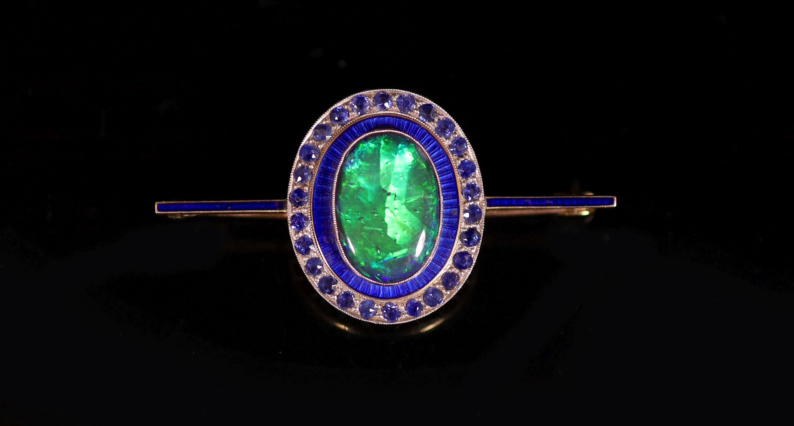 An early to mid 20th century gold, black opal doublet, blue enamel and millegrain sapphire set bar