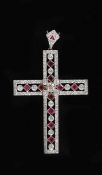 A modern pierced white gold, ruby and diamond cross pendant,set with round cut diamonds and square