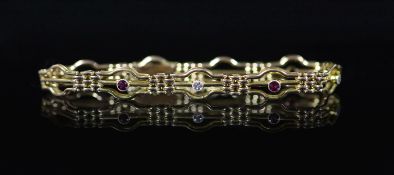 An Edwardian 15ct gold, three stone ruby and two stone diamond set fancy link bracelet,approx. 18cm,