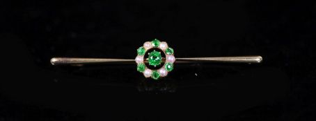 An early to mid 20th century gold, demantoid garnet and seed pearl circular cluster set bar brooch,
