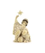 A Japanese ivory okimono of a mother and child, Meiji period,both kneeling, the mother holding a toy