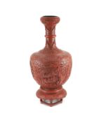 A large Chinese cinnabar lacquer garlic-neck vase and stand, c.1900,carved in high relief with