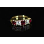 A Victorian style gold, three stone ruby and two stone diamond set half hoop ring,with carved