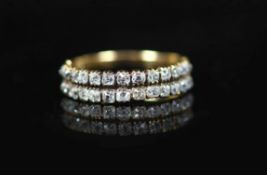 A 19th century gold and twin row old mine cut diamond set half hoop ring,with engraved shoulders and