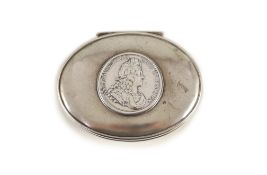 A George I silver oval snuff box,with hinged cover, the lid inset with medal commemorating the