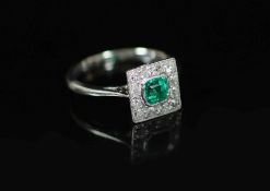 A 1920's platinum, emerald and diamond cluster set tablet ring,size H, gross 2.7 grams.