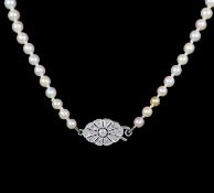 An early 20th century graduated pearl necklace, with platinum and millegrain set diamond clasp,42cm,