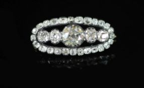 A Victorian gold, silver and graduated old cut diamond set oval brooch,the central stone weighing